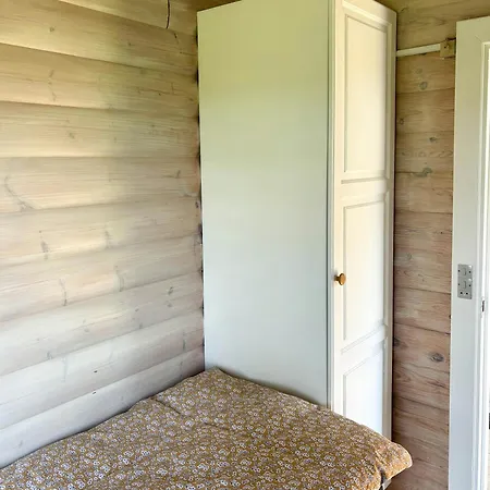 Log With View Of Meadow And Sea *