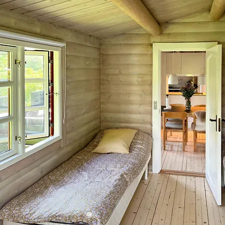 Log With View Of Meadow And Sea