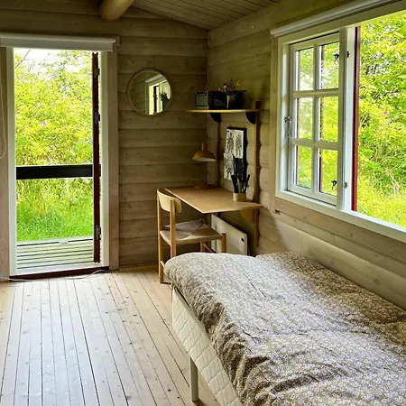 Log With View Of Meadow And Sea *