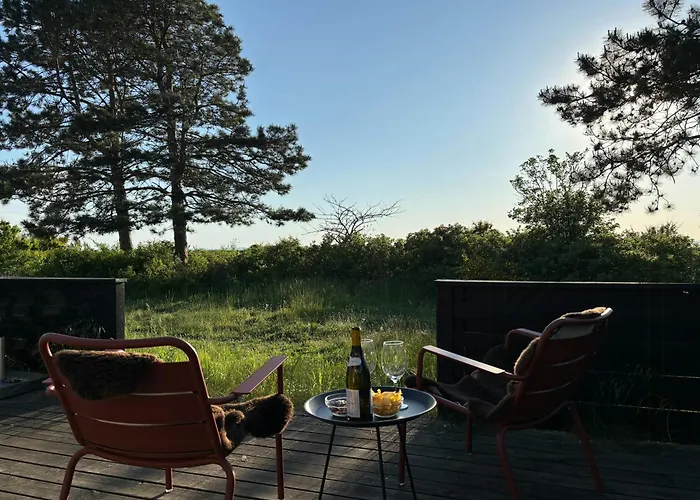 Log With View Of Meadow And Sea *