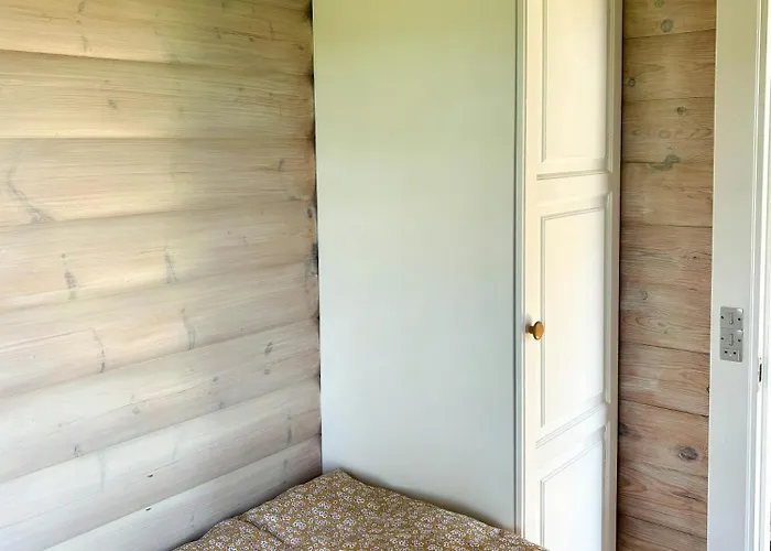 Log With View Of Meadow And Sea *