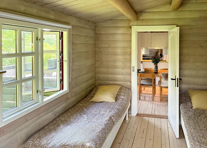 Log With View Of Meadow And Sea