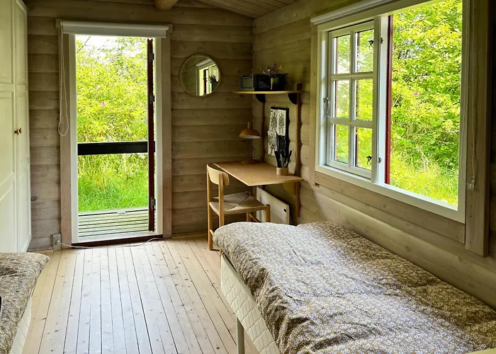 Log With View Of Meadow And Sea *