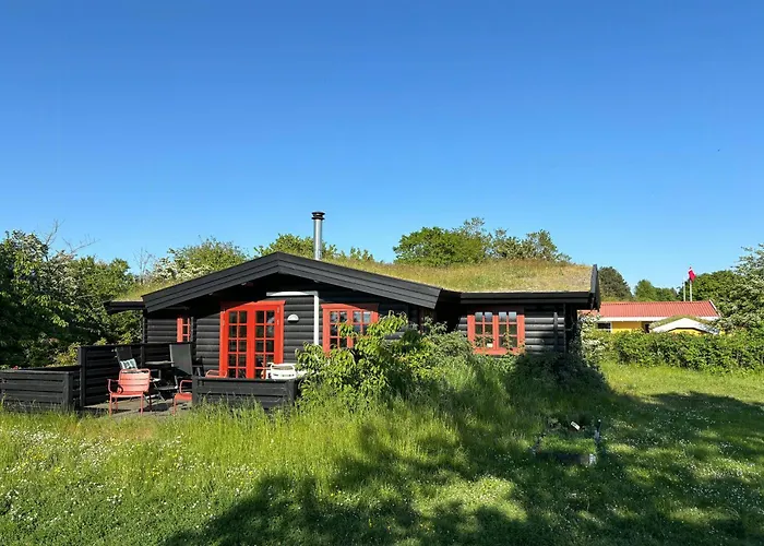 Log With View Of Meadow And Sea *
